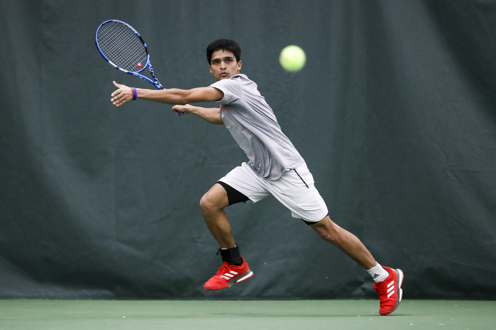 Vikash Singh, Nashville tennis coach, mid-forehand on an indoor court